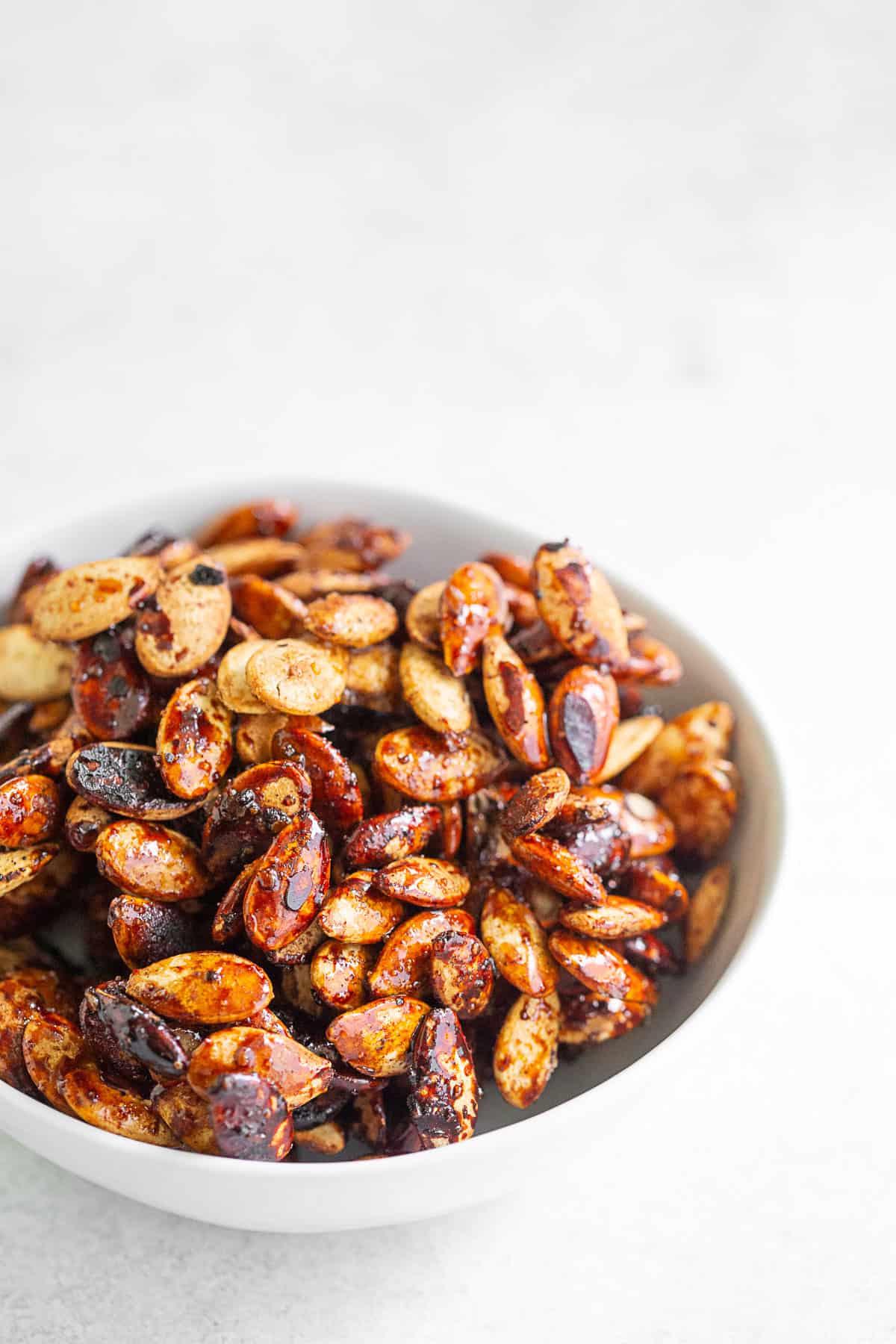 Sweet Salty Roasted Pumpkin Seeds in a small white bowl.