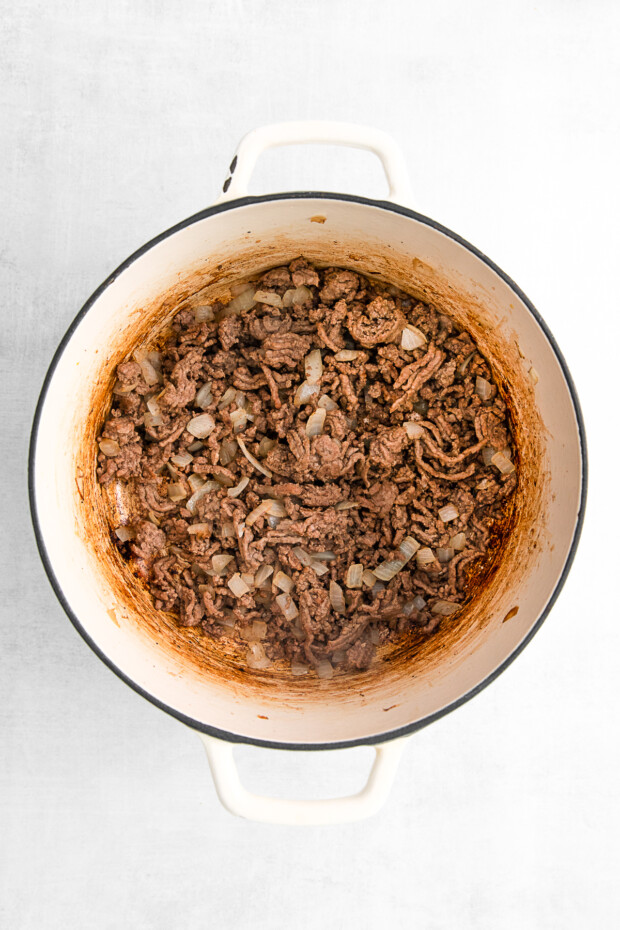 Ground beef and onions in a dutch oven. 