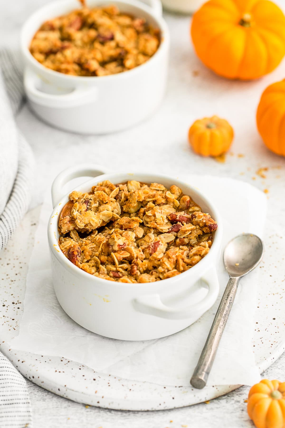 Pumpkin Crisp in a ramekin with a spoon.