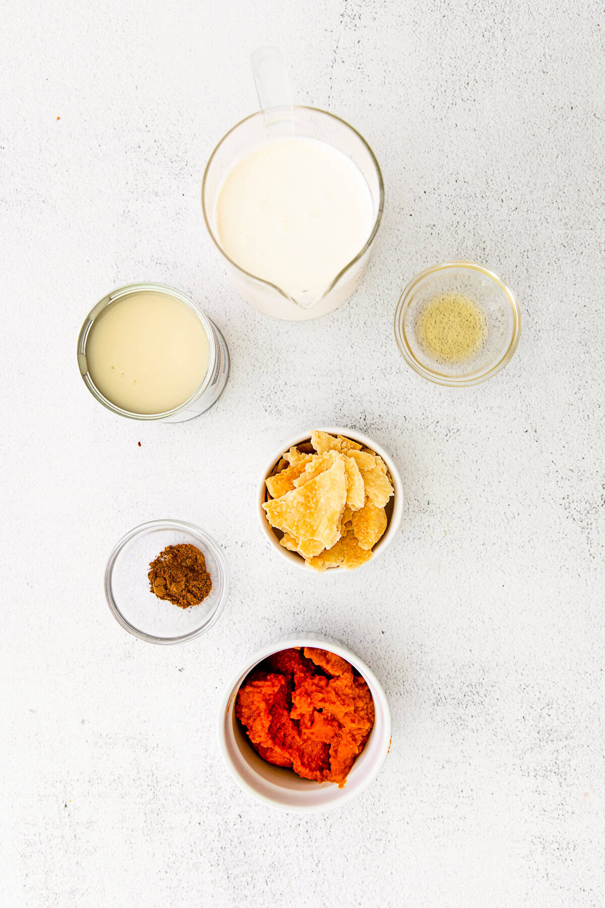 Ingredients to make pumpkin pie ice cream on a table.