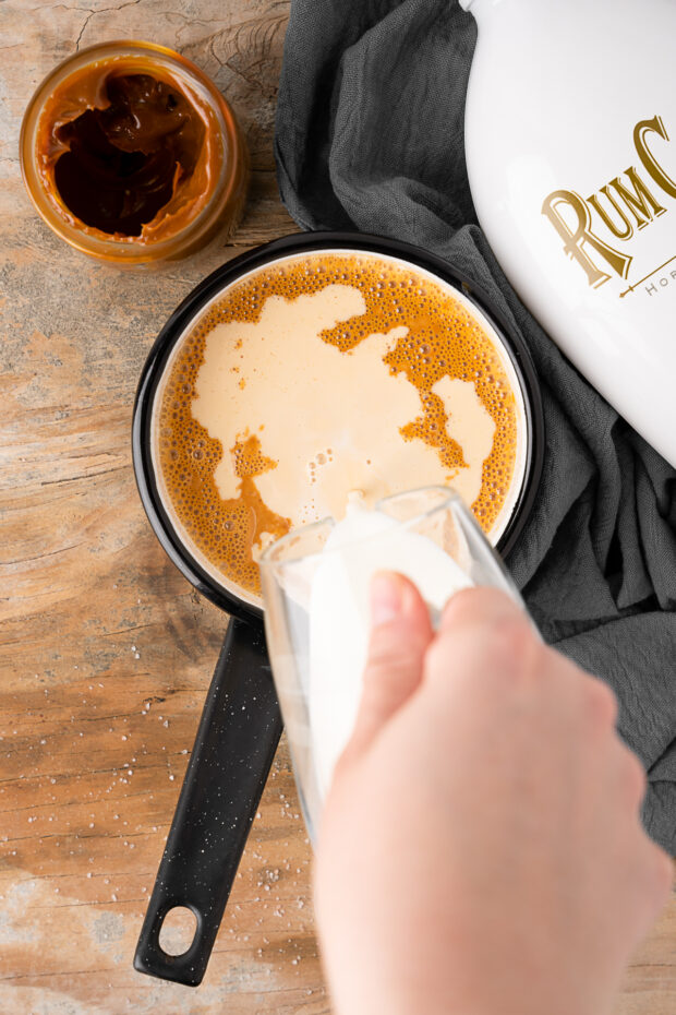 Rumchata being poured into dulce de leche. 