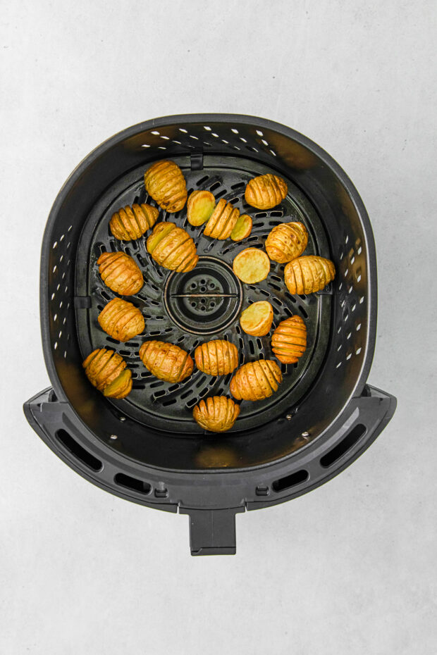 Air Fryer Hasselback Potatoes cooked in the air fryer basket.