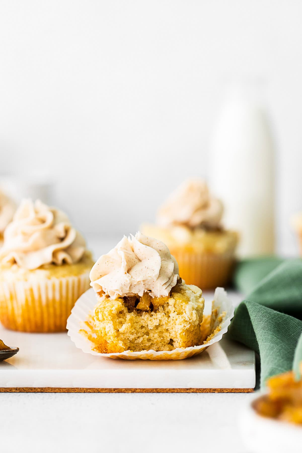 Apple Pie Cupcakes with a bite taken out to show the filling. 