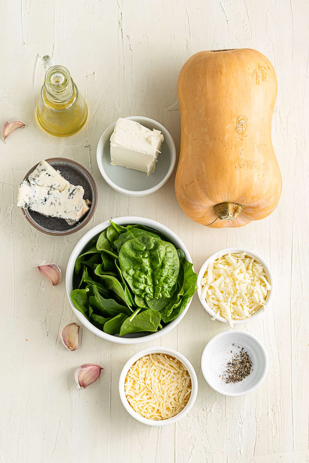 Ingredients to make Cheese Stuffed Butternut Squash on a table. 