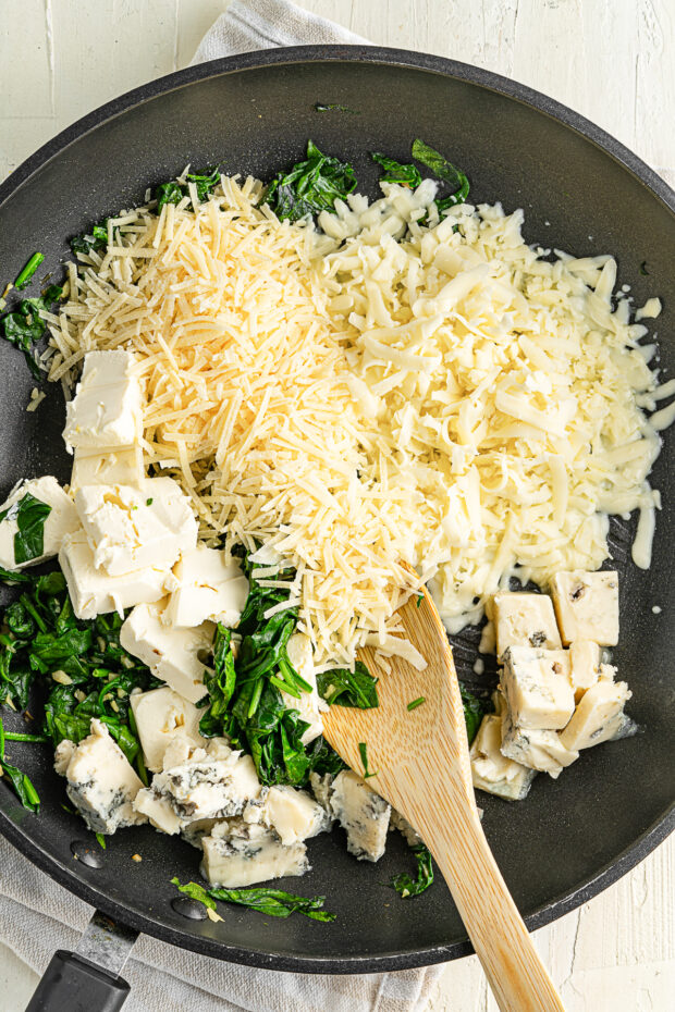Cheese and spinach in a skillet. 