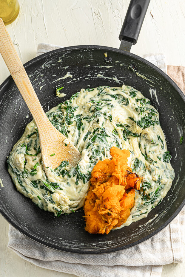 Cheese sauce with squash getting mixed in. 