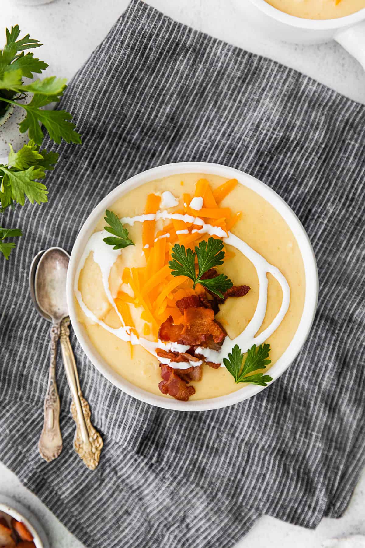 Instant Pot Loaded Potato Soup topped with cheese, bacon, and sour cream. 