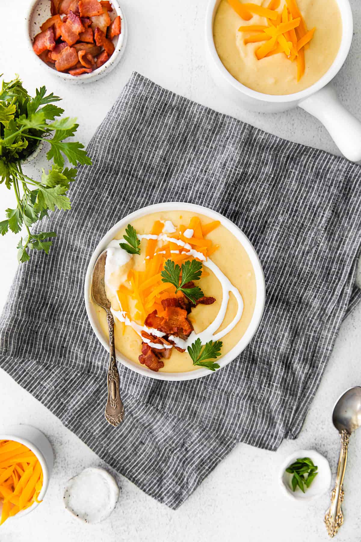 Instant Pot Loaded Potato Soup drizzled with sour cream. 