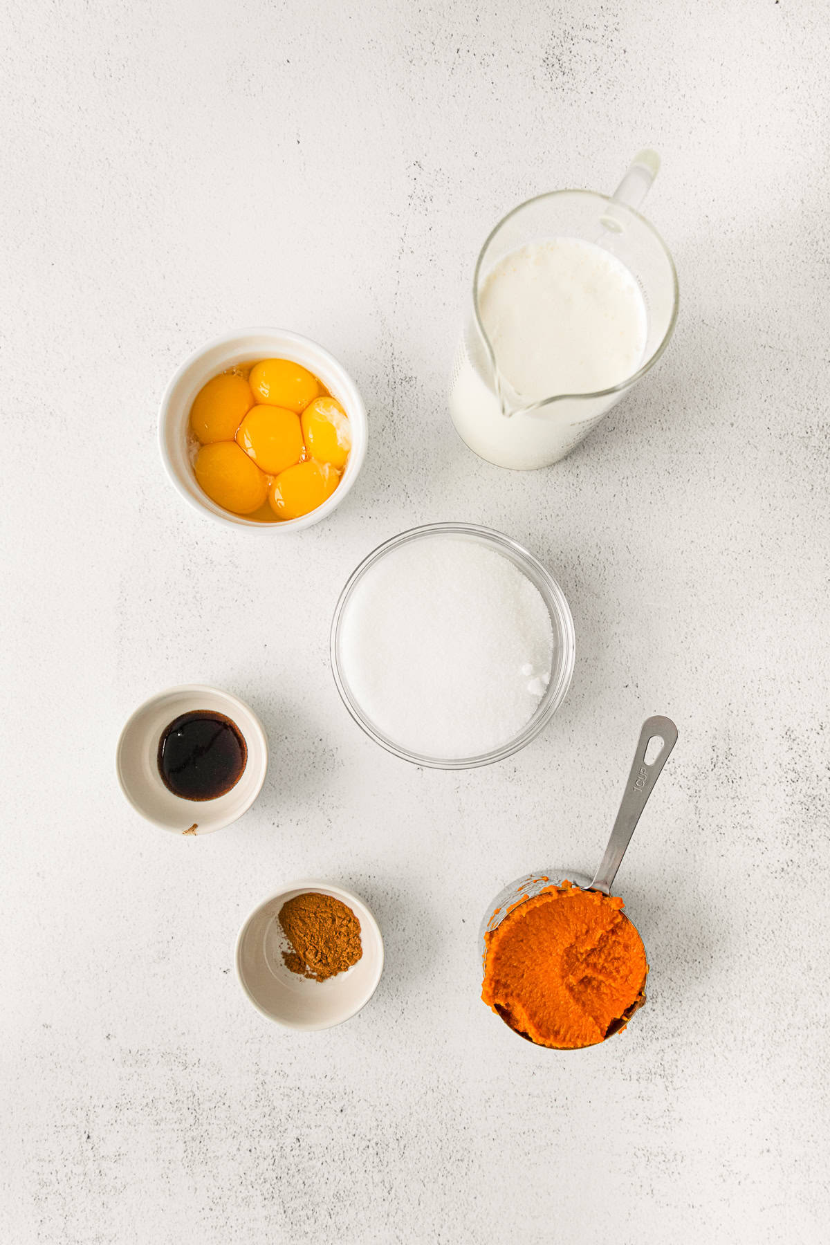 Ingredients for Pumpkin Creme Brulee on a table. 
