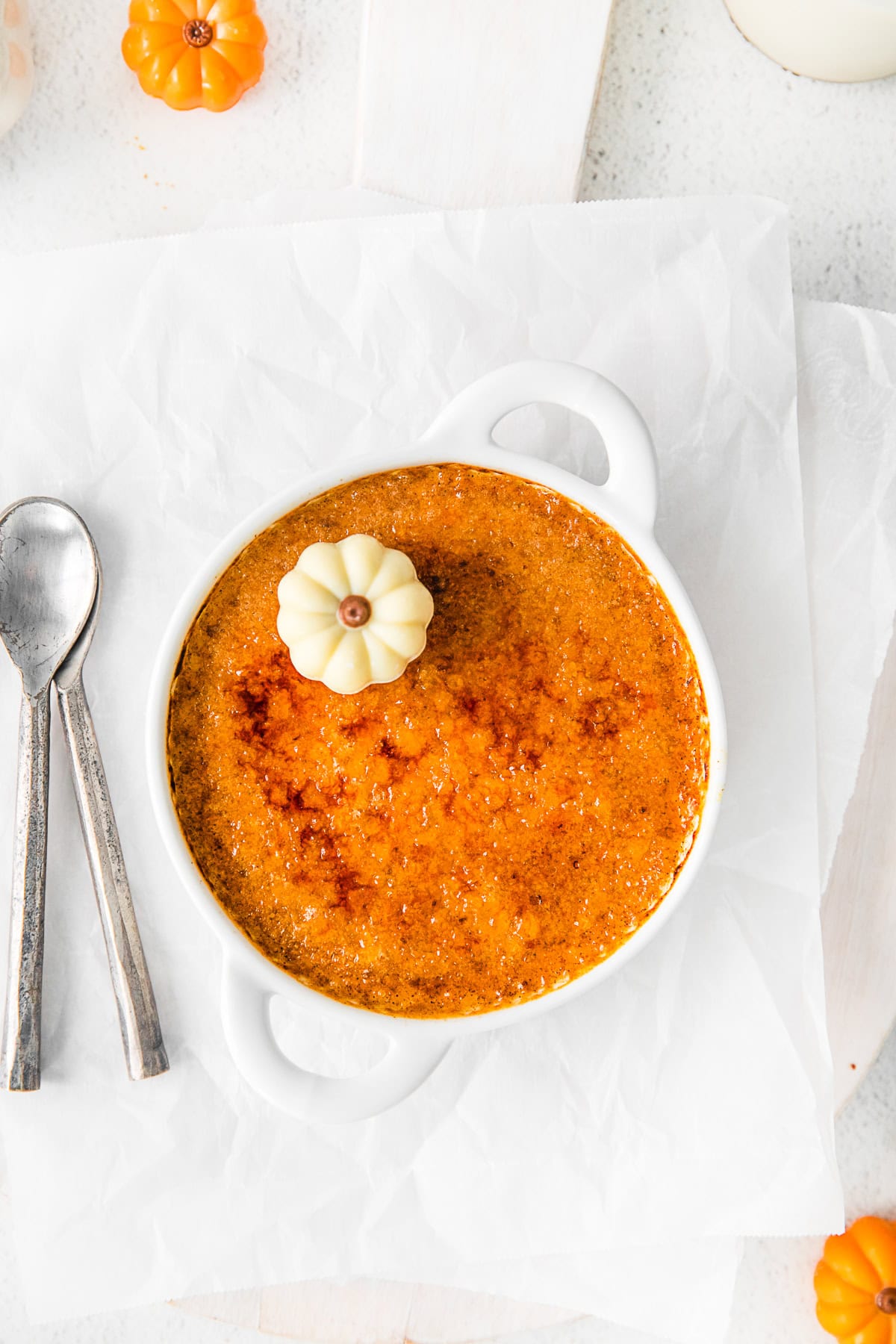 Pumpkin Creme Brulee sitting on parchment paper. 