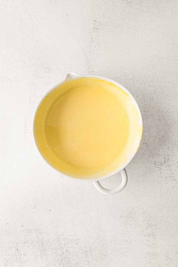 Warm milk and eggs in a bowl. 