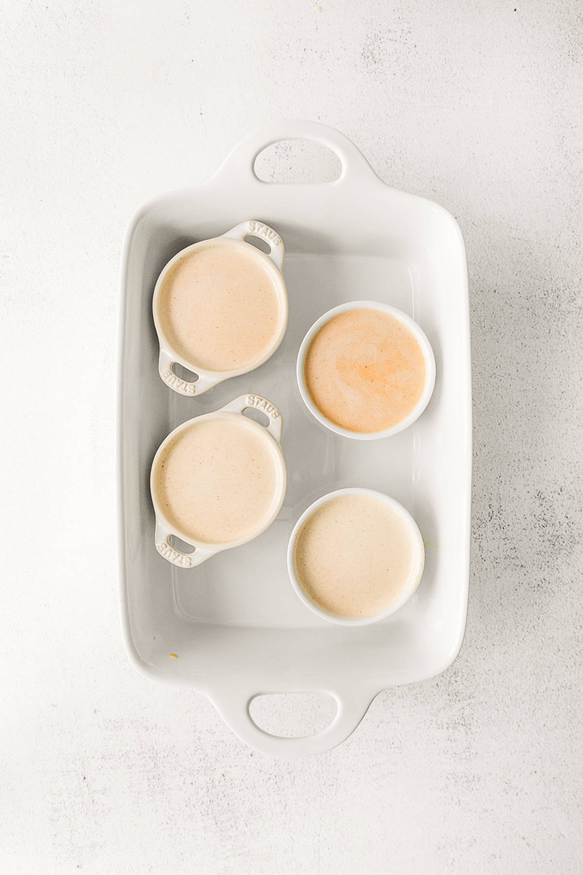 Uncooked creme brulee in ramekins. 