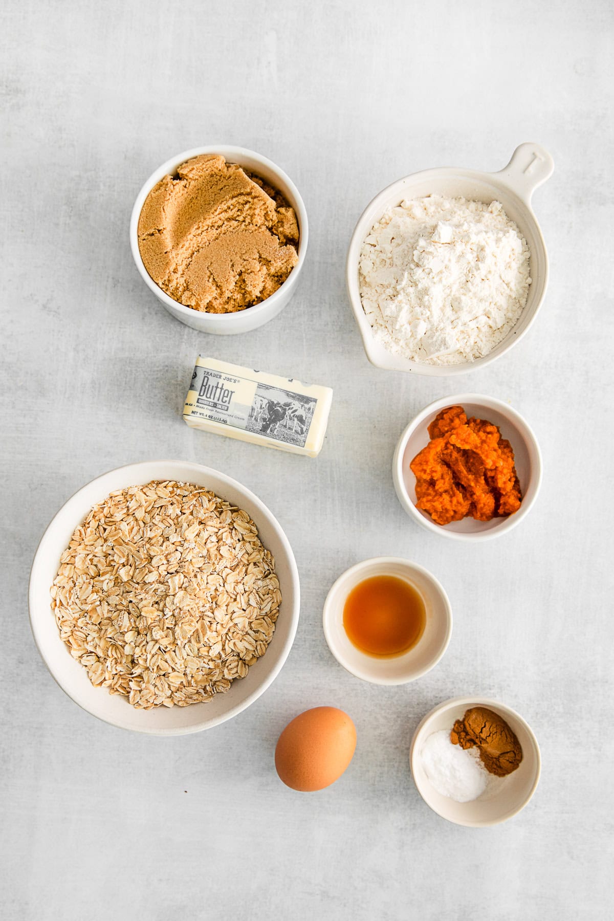 Ingredients to make Pumpkin Oatmeal Cookies on a table. 