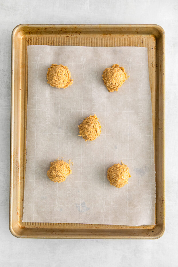 Uncooked Pumpkin Oatmeal Cookies on a sheet pan. 