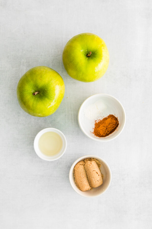 Ingredients to make spiced apples on a table. 
