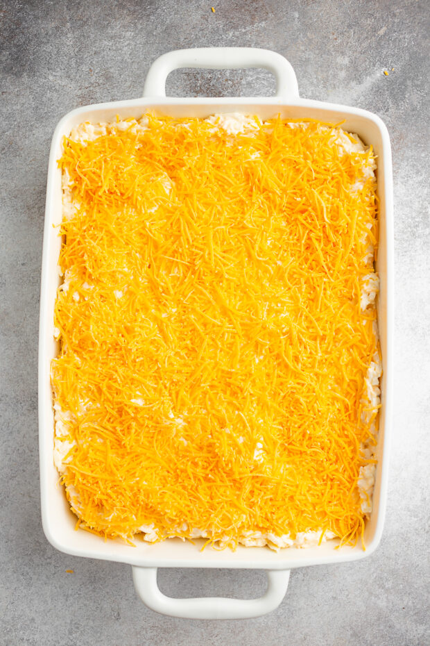 Hashbrown casserole topped with cheese but not baked. 