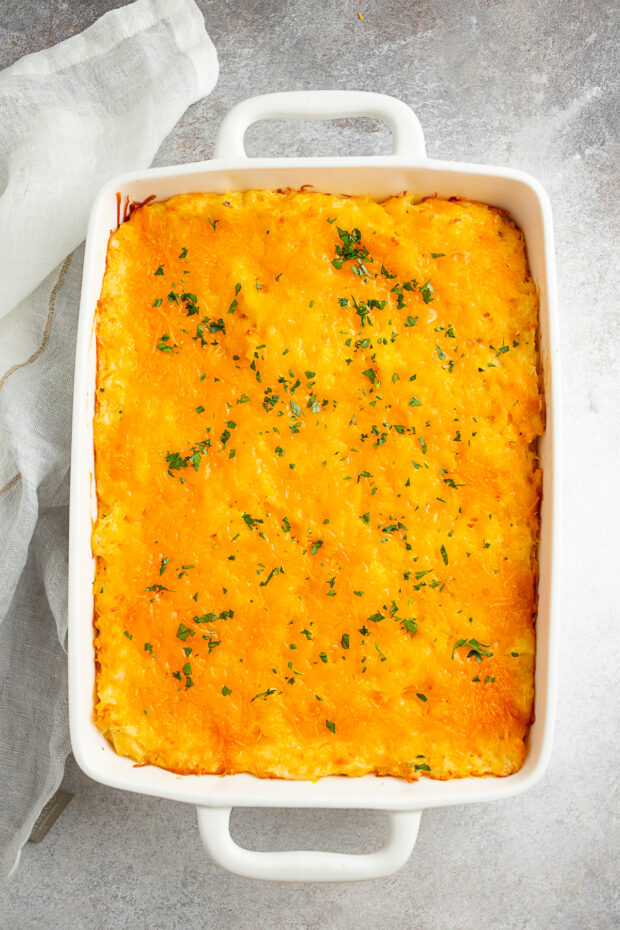 Cheesy Potatoes (Funeral Potatoes) cooked in a casserole dish. 