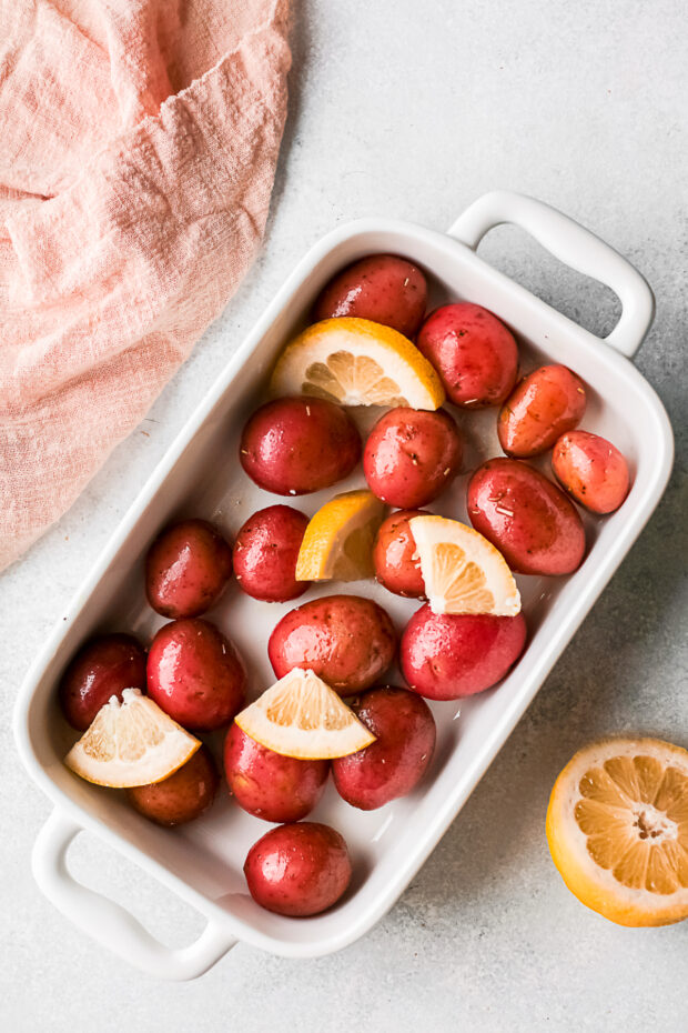 Unbaked red potatoes and lemon slices. 