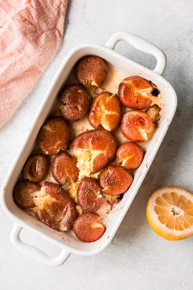 Smashed potatoes in a dish. 