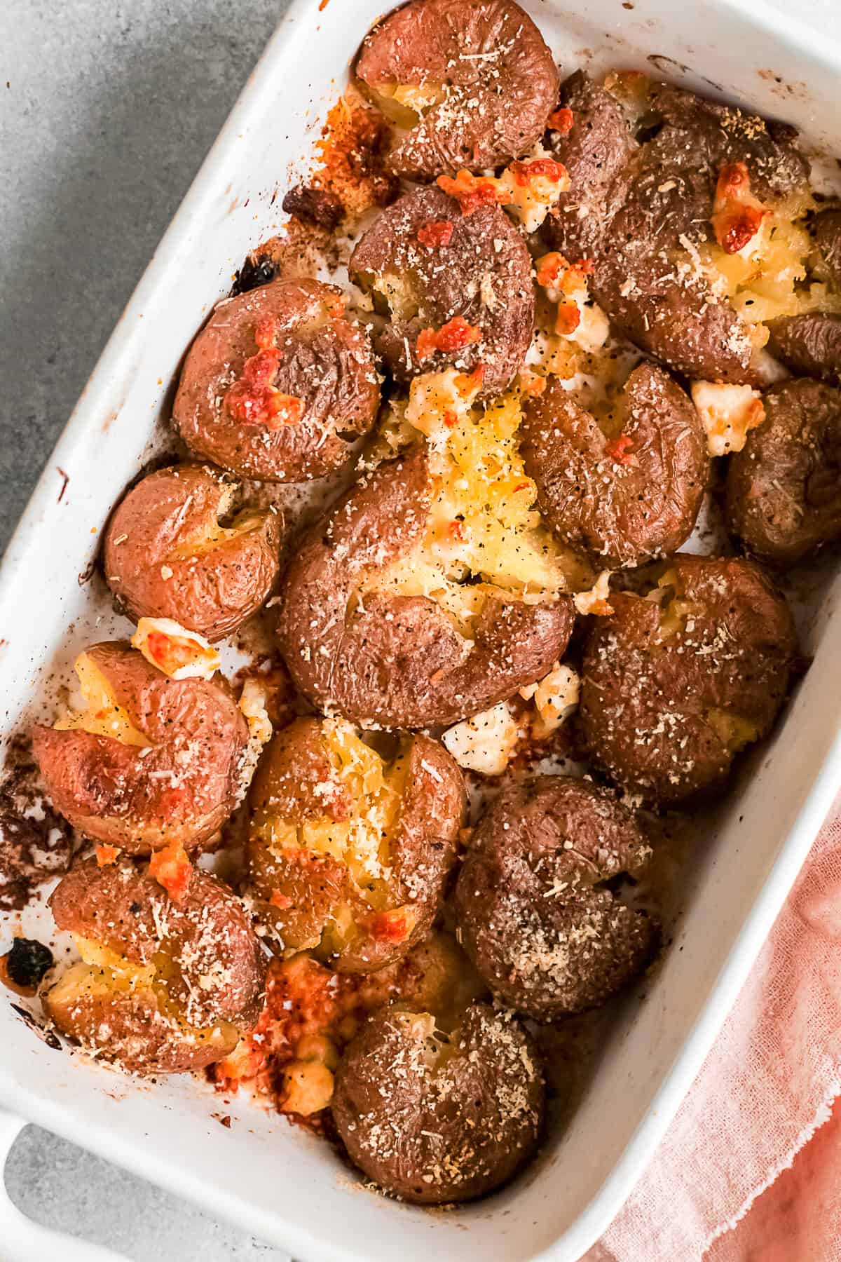 Cheesy Smashed Potatoes in a dish. 