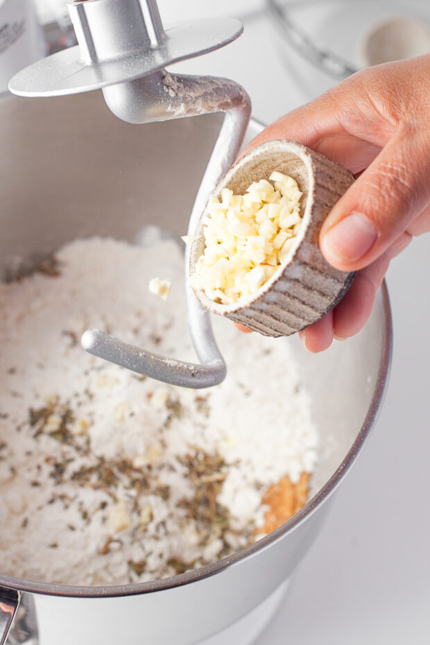 Adding garlic to bread dough. 