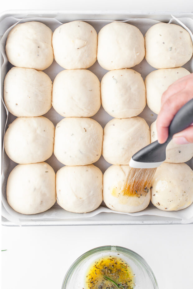 Brushing rolls with melted butter. 