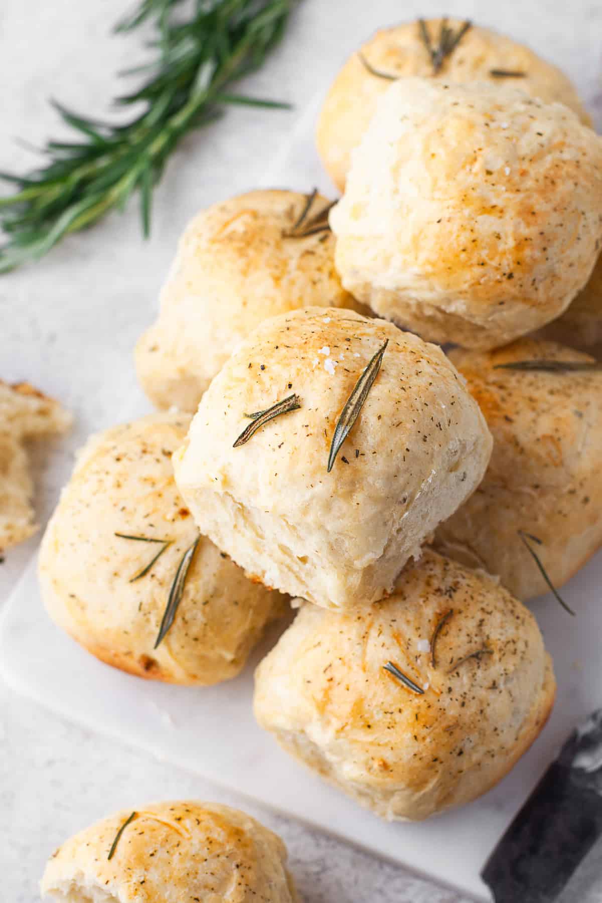 Garlic Herb Dinner Rolls on a cutting board. 