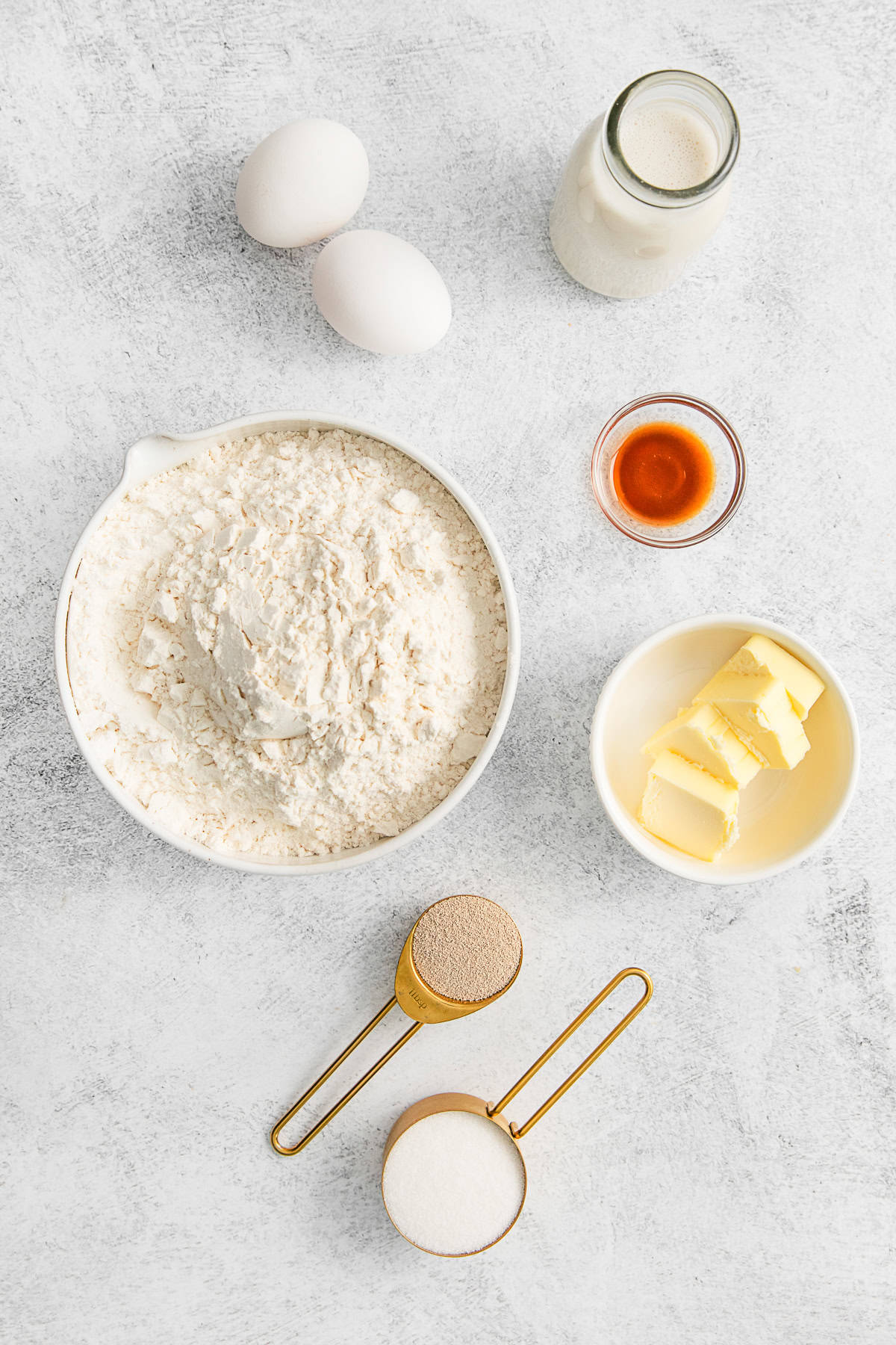 Ingredients for cinnamon roll dough on a table.
