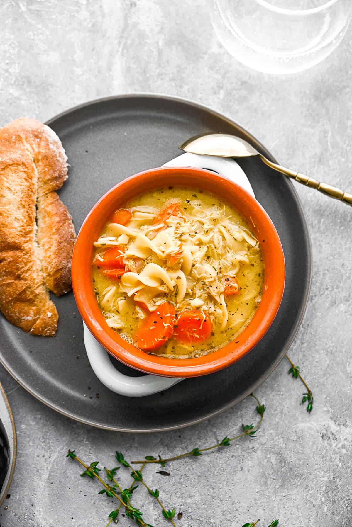Leftover Turkey Noodle Soup on a plate with bread. 