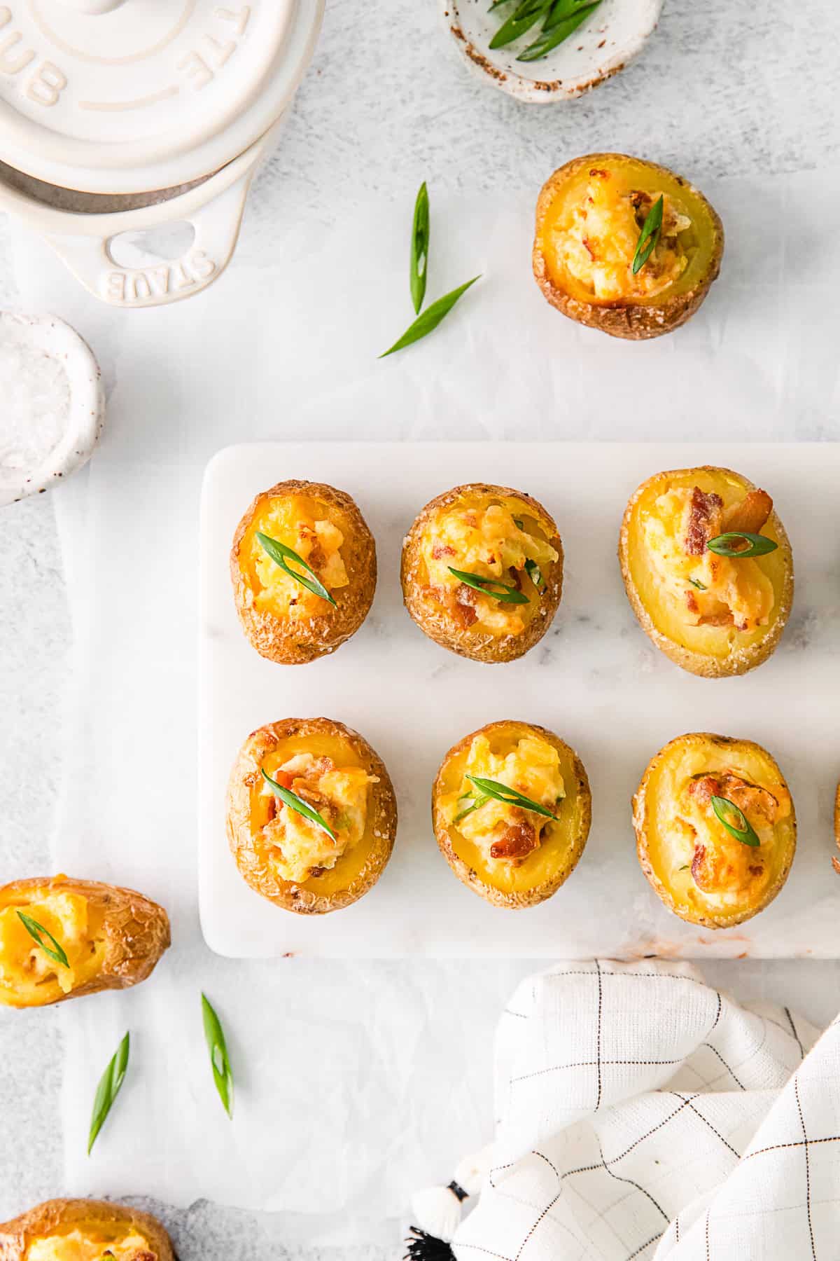 Mini Loaded Baked Potatoes on a marble serving board. 
