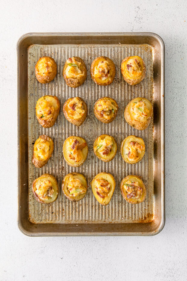 Mini Loaded Baked Potatoes on a sheet pan. 