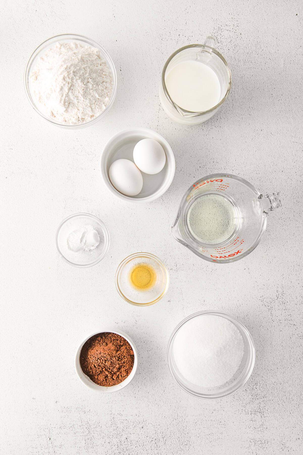 Ingredients to make chocolate cupcakes on a table. 