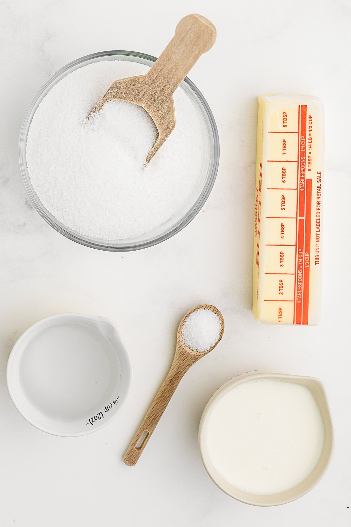 Ingredients to make Salted Caramel Sauce on a table.