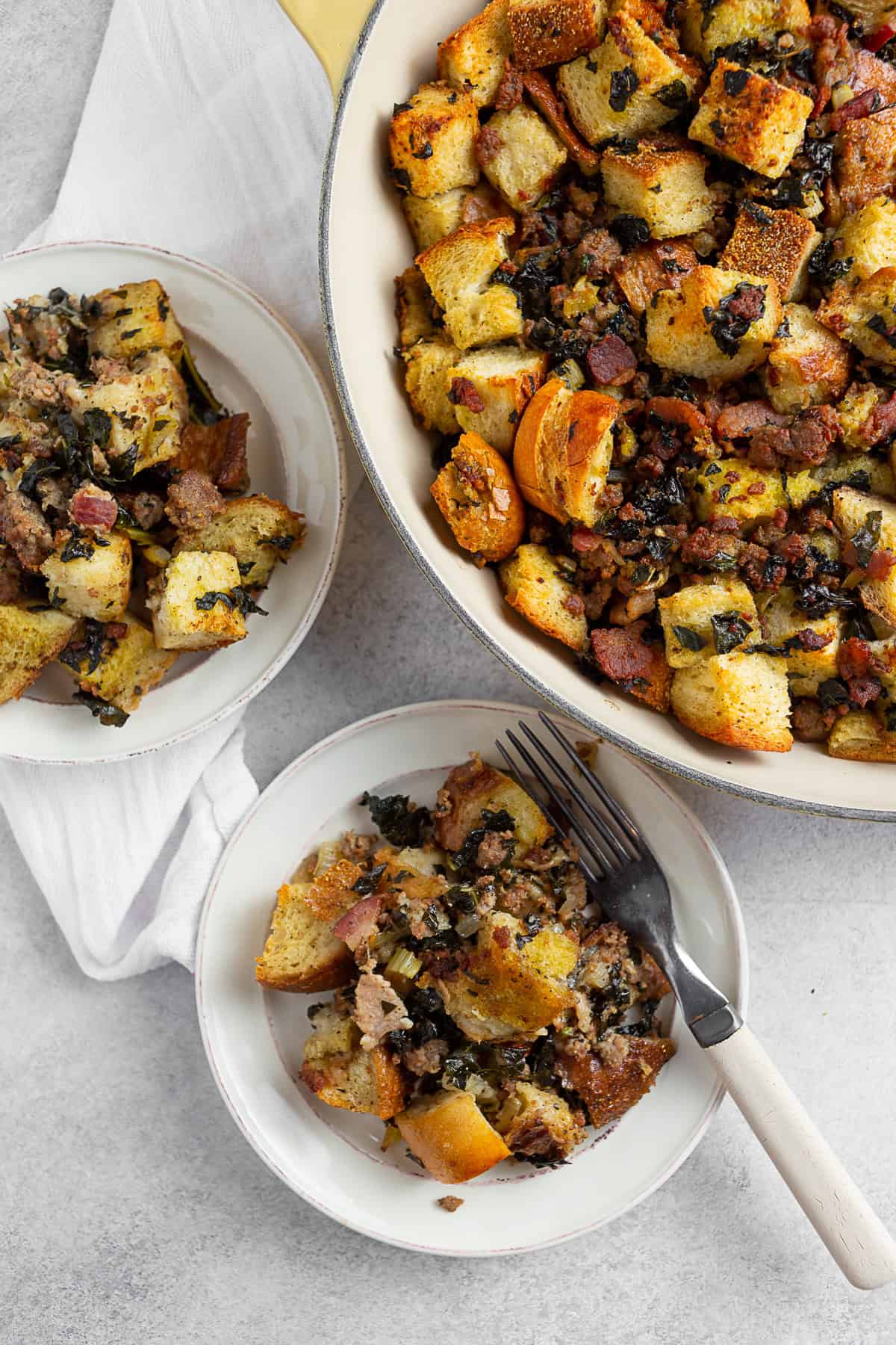 Sourdough Kale Bacon Sausage Stuffing served on a white plate. 