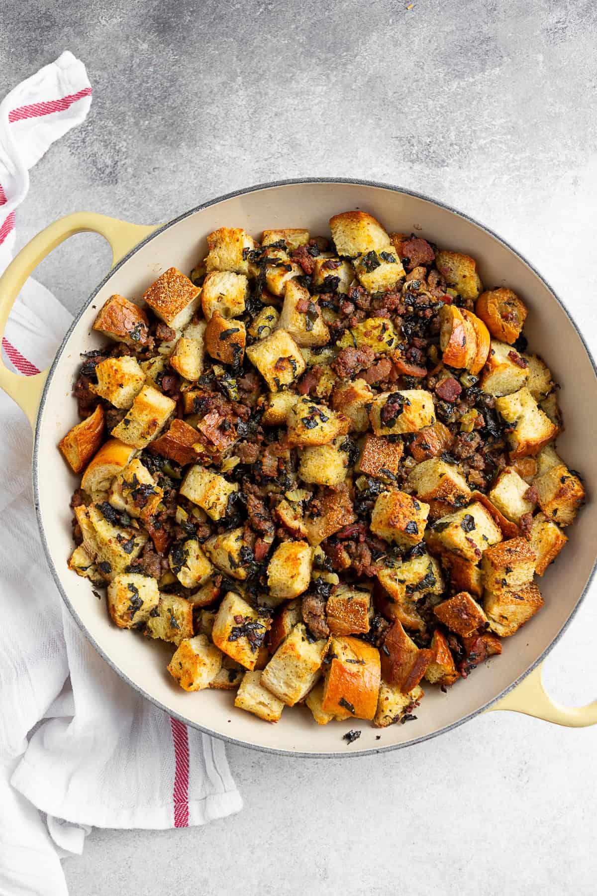 Sourdough Kale Bacon Sausage Stuffing in a round skillet. 