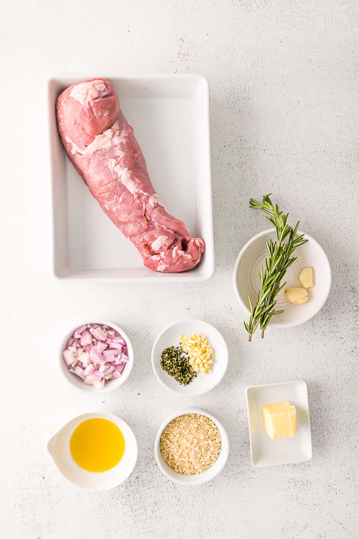 Ingredients to make Stuffed Pork Tenderloin on a table.
