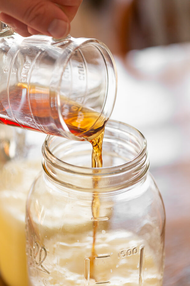 Rum being poured into aged eggnog.