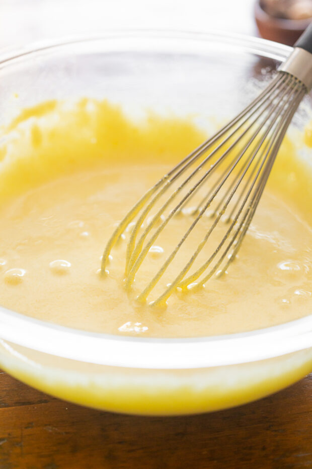 Fully mixed egg yolks and sugar in a glass bowl.