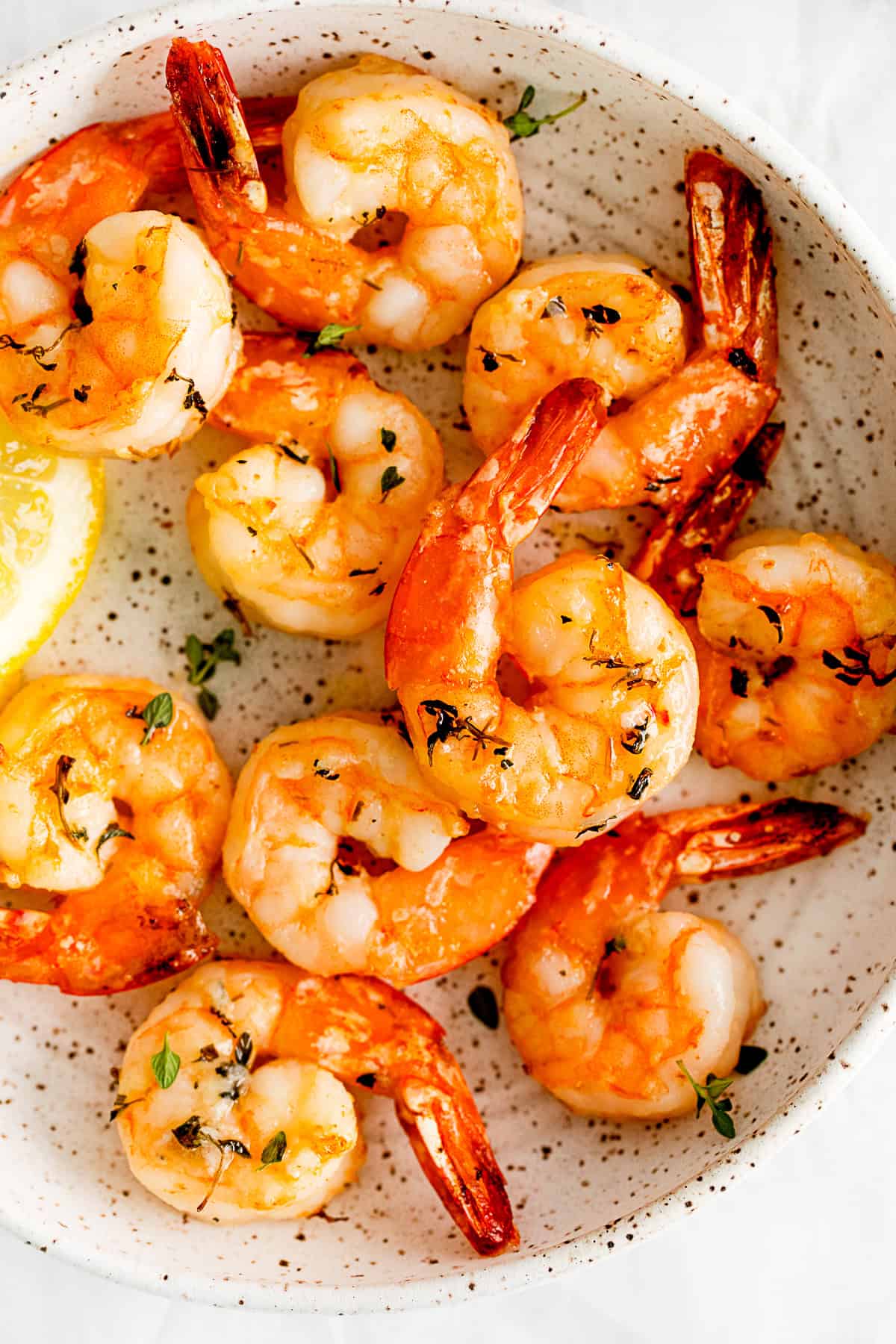 Air Fryer Shrimp sprinkled with fresh thyme.