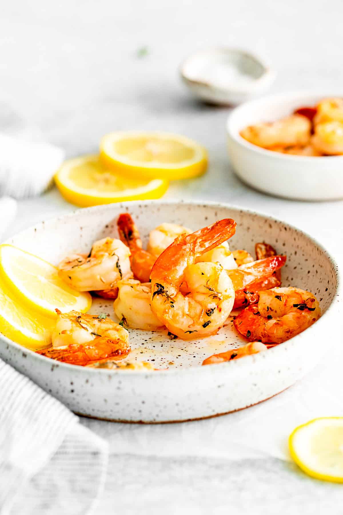 Air Fryer Shrimp in a bowl with lemon.