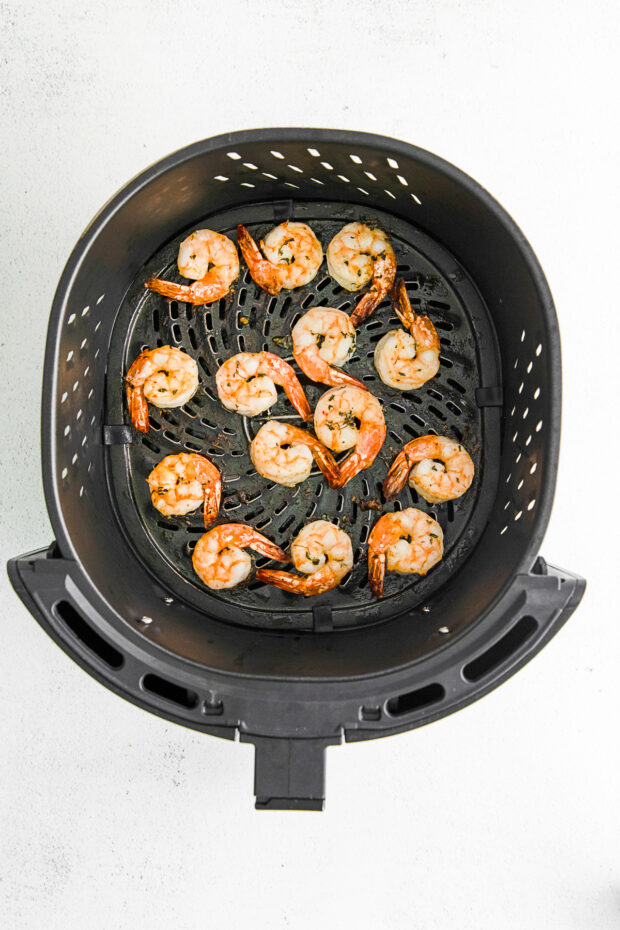 Air Fryer Shrimp in an air fryer basket.