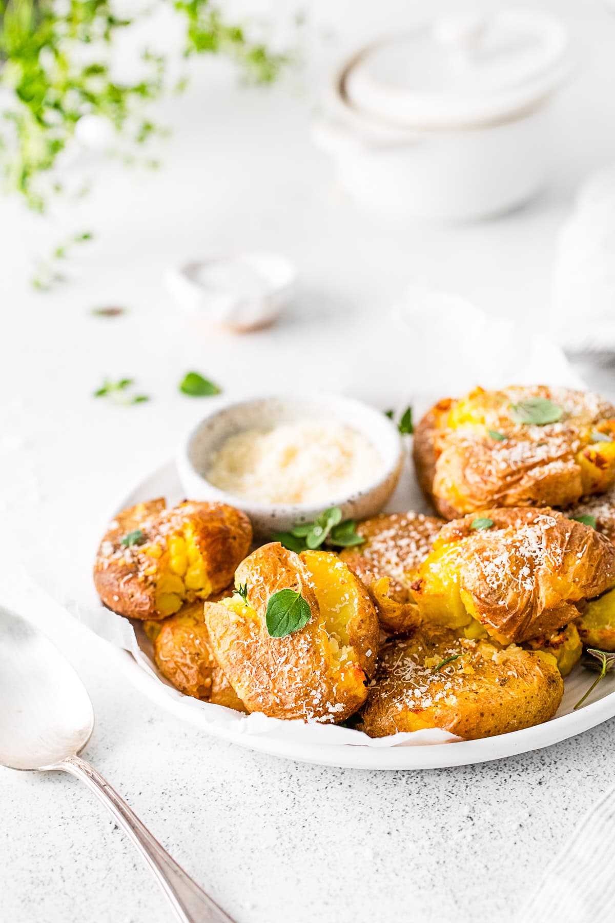 Air Fryer Smashed Potatoes on a plate with parmesan cheese. 