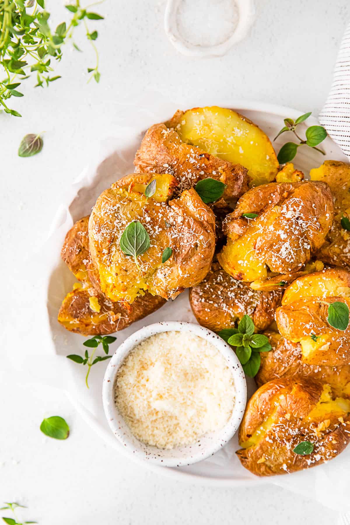 Air Fryer Smashed Potatoes topped with fresh herbs. 