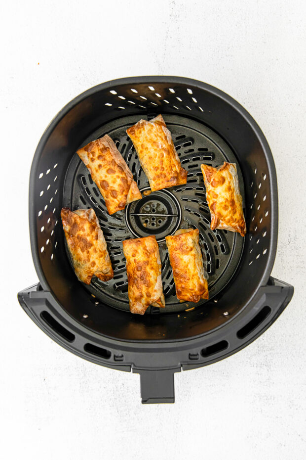 Cooked air fryer cheeseburger egg rolls.