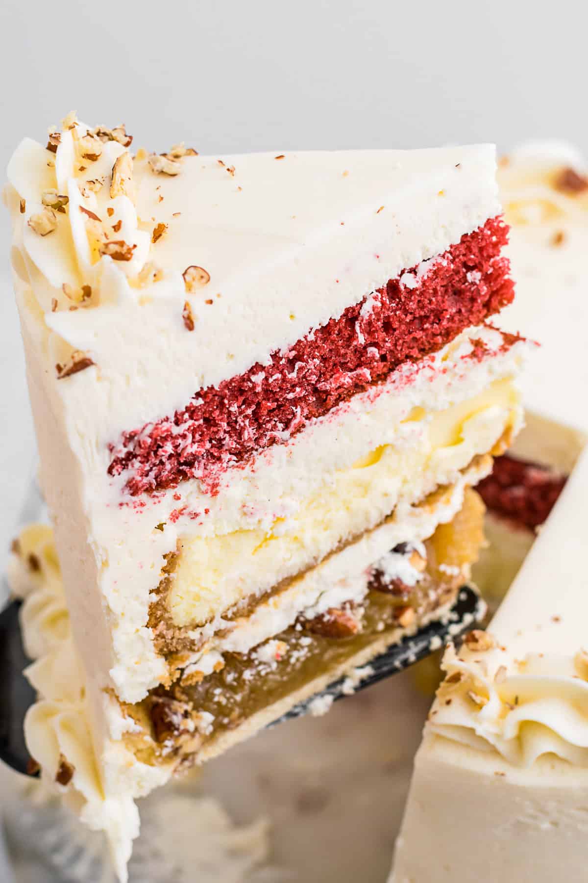 A slice of piecaken being taken from the whole cake. 