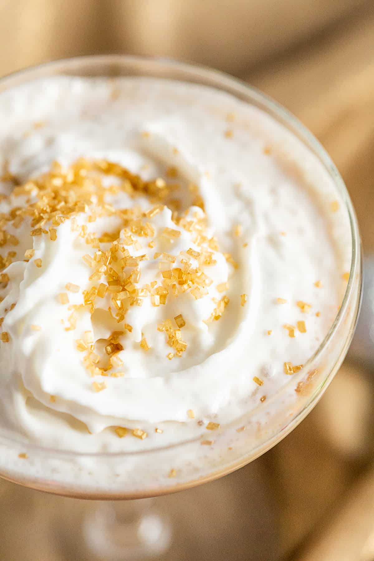 Gingerbread Martini topped with whipped cream and colored sugar. 