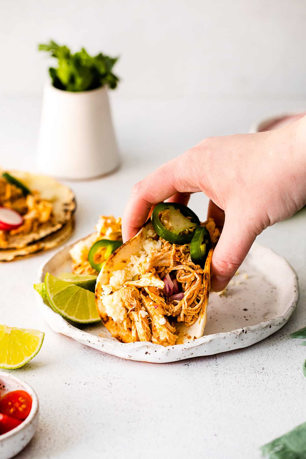 Instant Pot Chicken Tacos being picked up. 