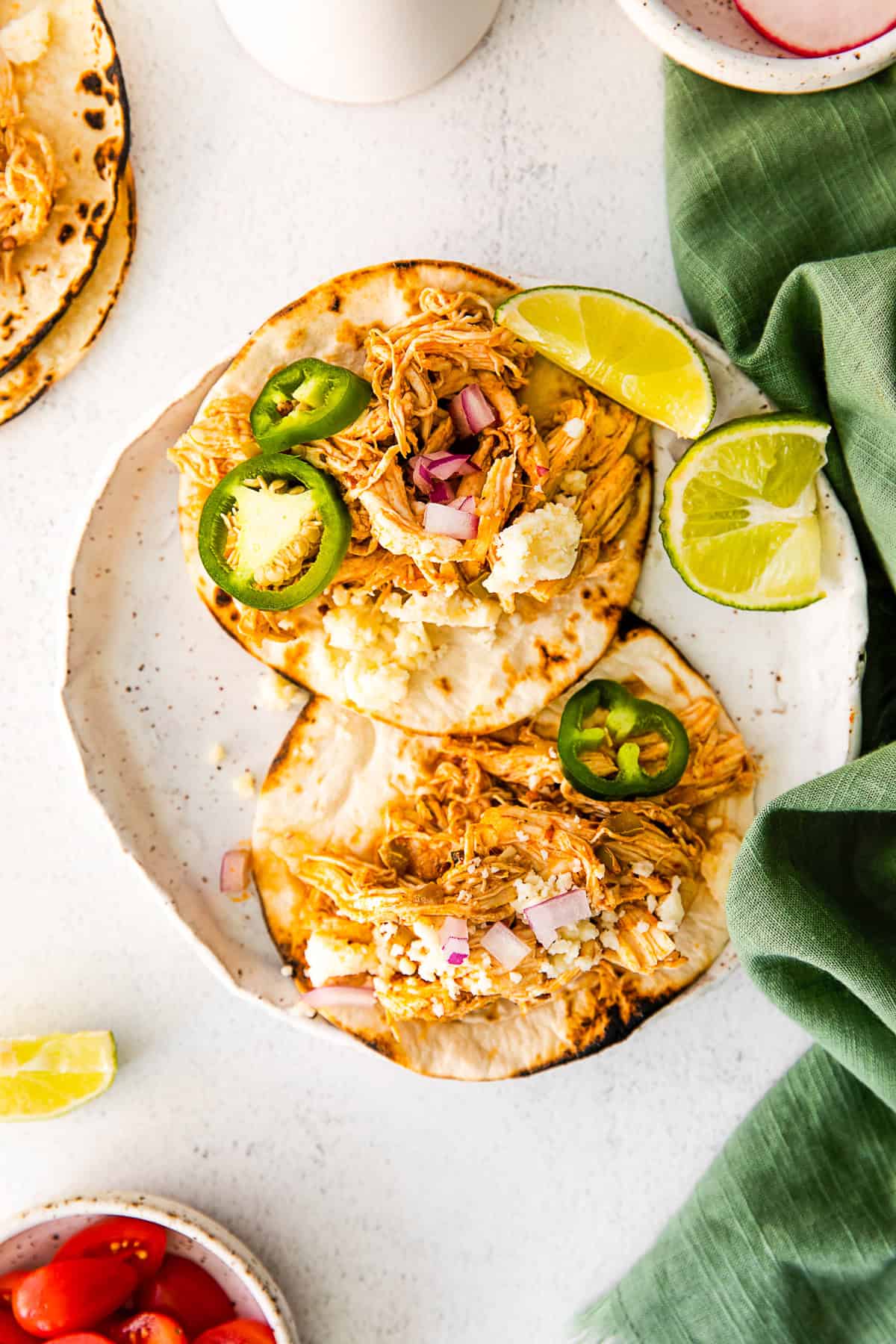 Instant Pot Chicken Tacos on a white plate. 