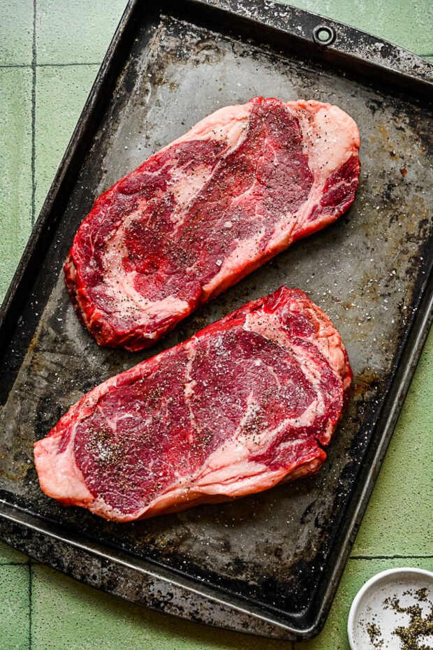 Seasoned steak with salt and pepper. 