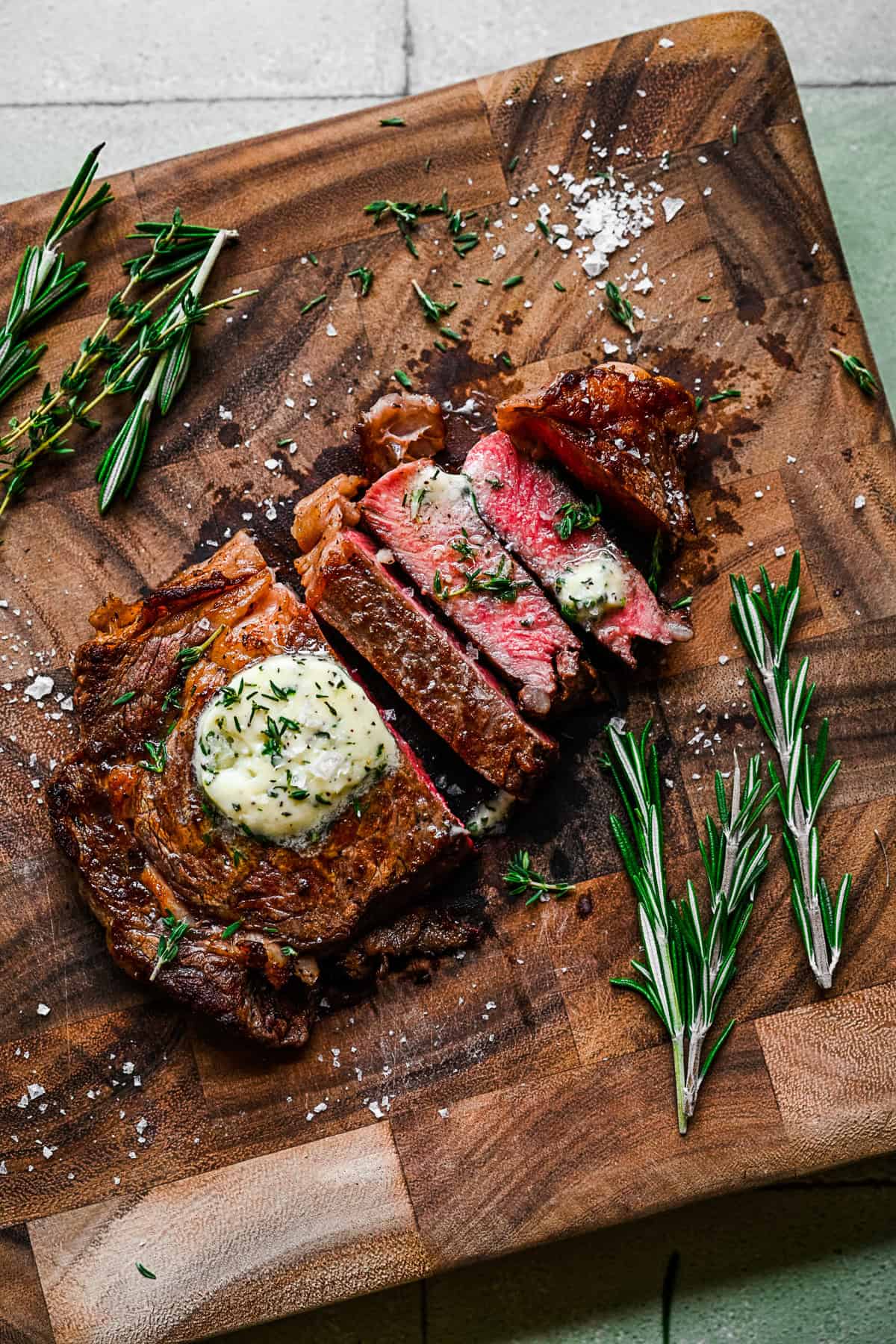 Pan Fried Ribeye sliced on a cutting board. 